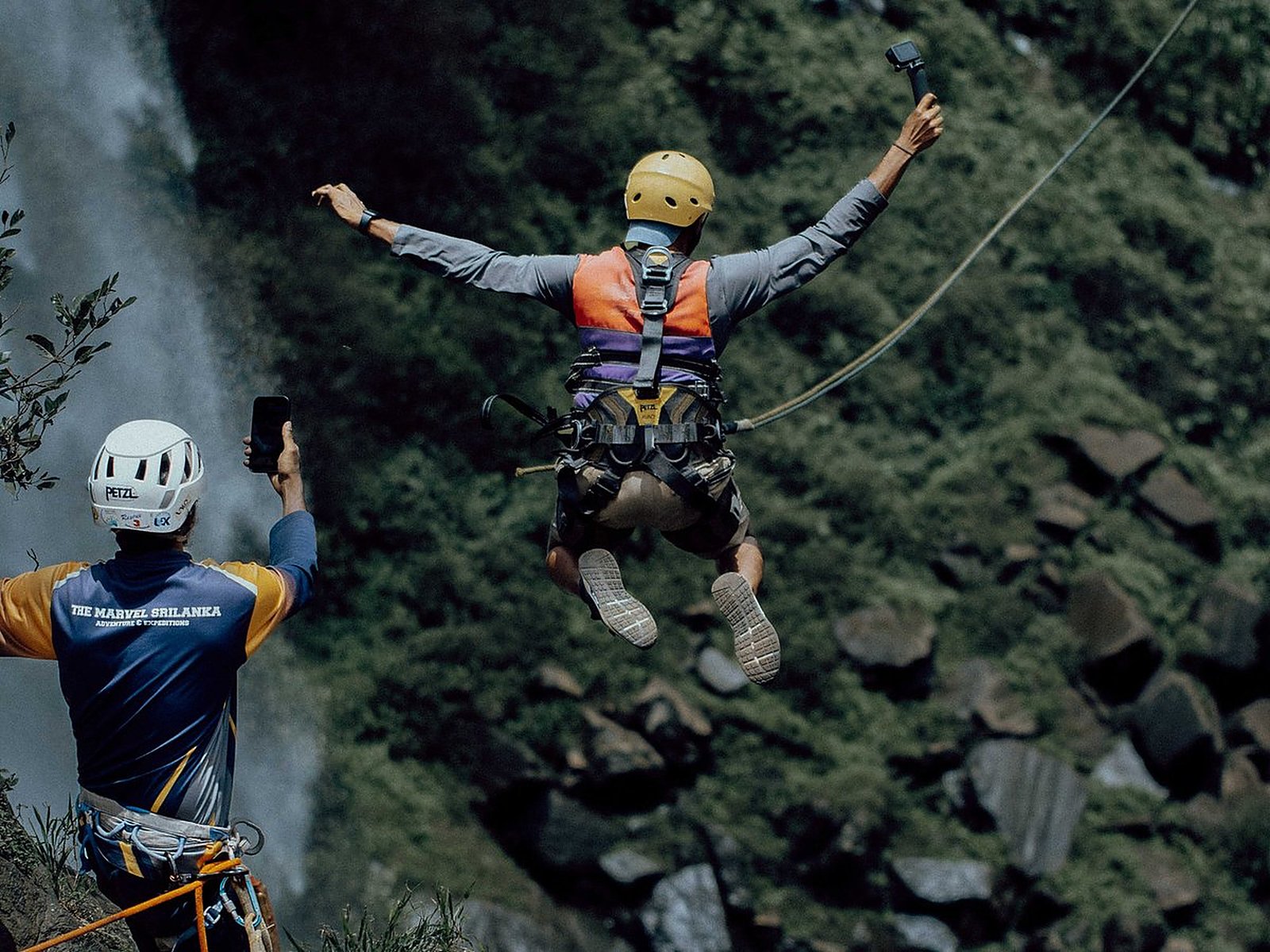Canyoning by a waterfall